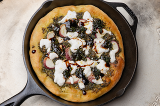 lodge cast iron skillet pizza with pesto base, peaches and burrata