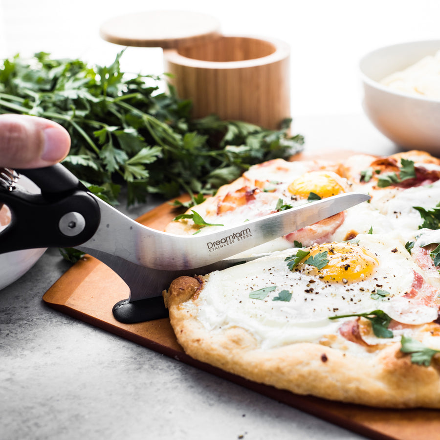 https://www.boroughkitchen.com/cdn/shop/products/dreamfarm-scizza-pizza-scissor-black-lifestyle-borough-kitchen_900x900.jpg?v=1624543335