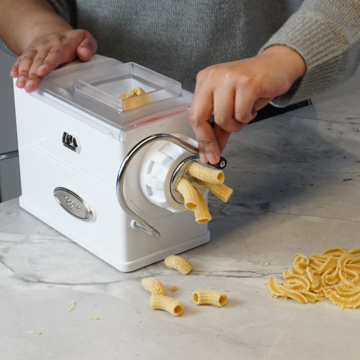 https://www.boroughkitchen.com/cdn/shop/products/marcato-regina-pasta-extruder-machine-cutting-dough-borough-kitchen_2048x2048.jpg?v=1679501179