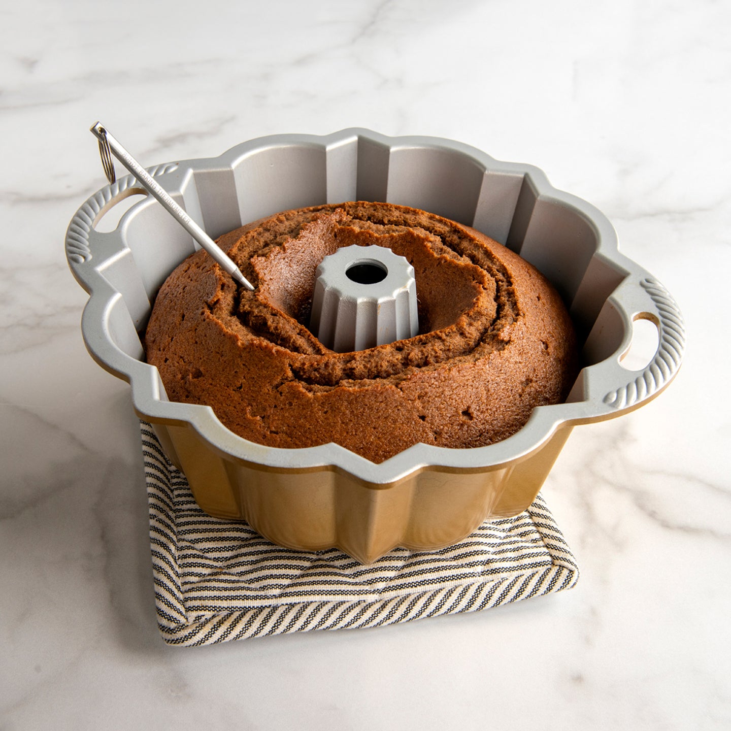 https://www.boroughkitchen.com/cdn/shop/products/nordic-ware-cake-tester-in-cake-borough-kitchen_6d8aa783-0682-45e4-af71-d36a1db35266_2048x2048.jpg?v=1599919301