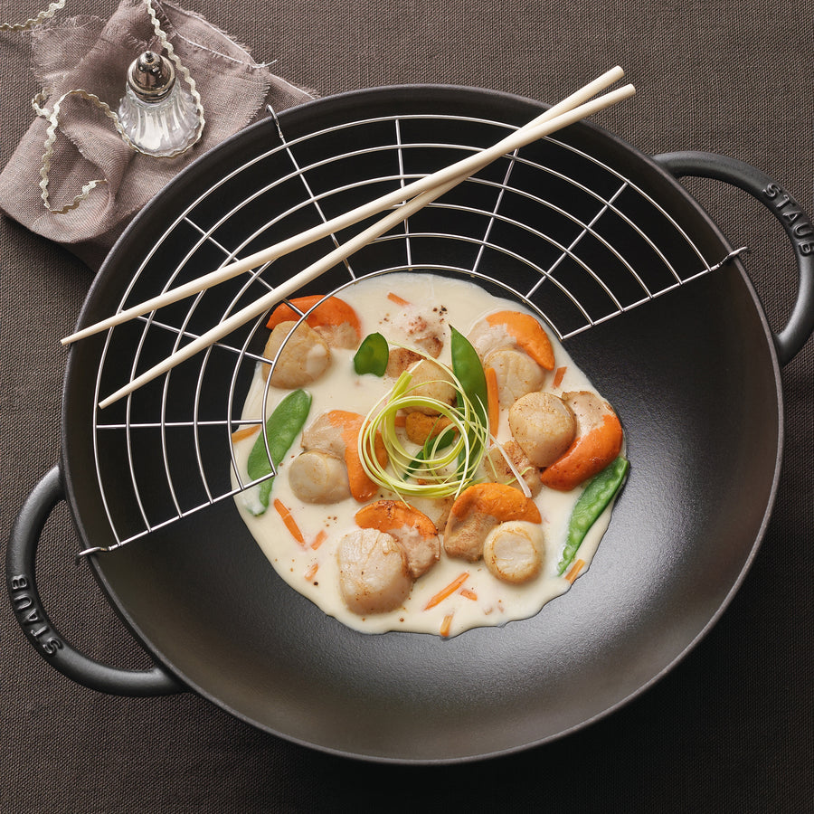 https://www.boroughkitchen.com/cdn/shop/products/staub-cast-iron-wok-37cm-lifestyle-borough-kitchen_900x900.jpg?v=1612185208