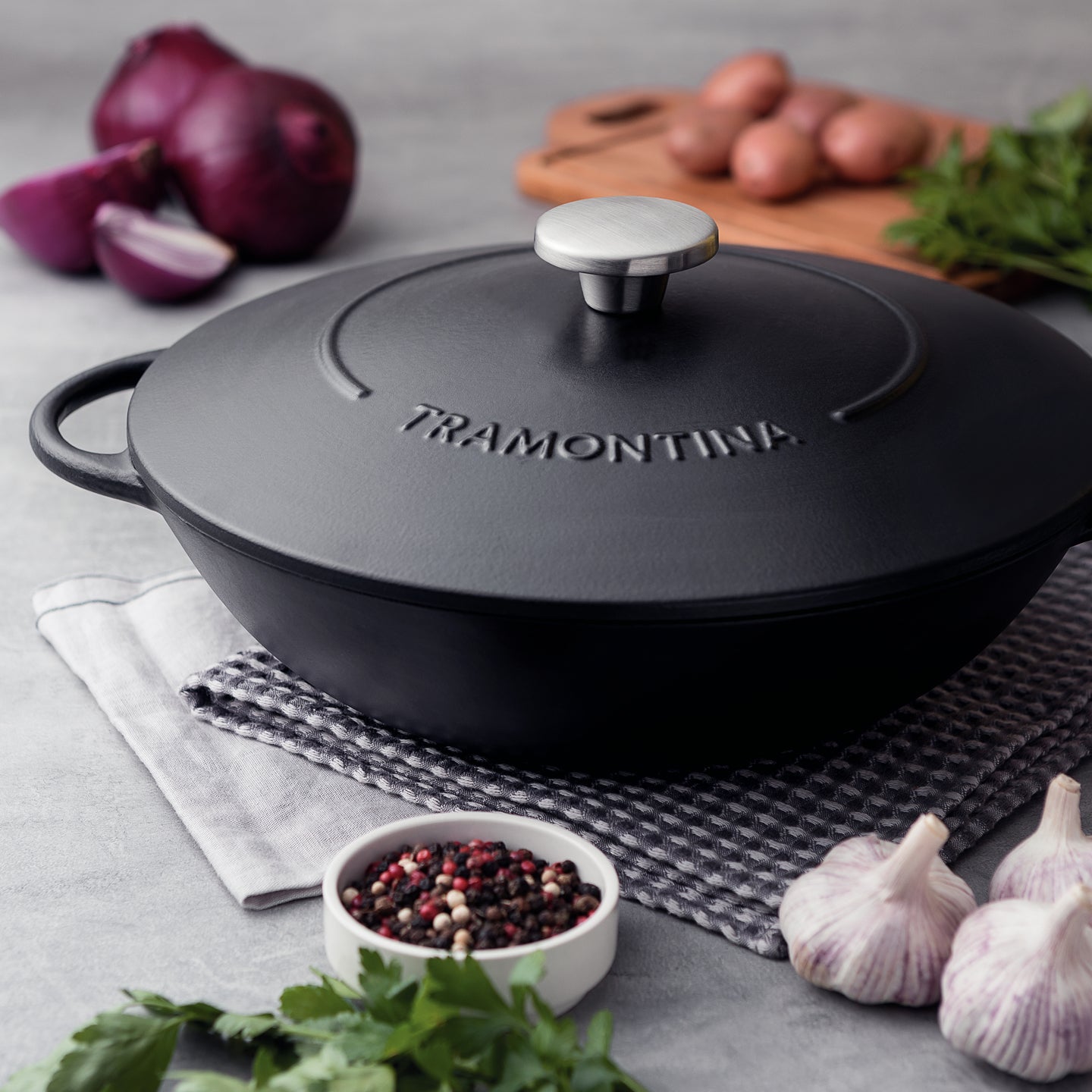 https://www.boroughkitchen.com/cdn/shop/products/tramontina-enamelled-cast-iron-wok-black-32cm-lifestyle-borough-kitchen_2048x2048.jpg?v=1636044087